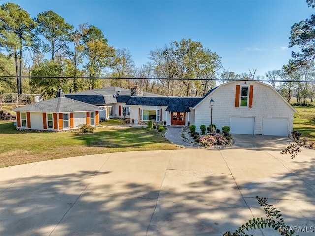 ranch-style house featuring a garage and a front yard