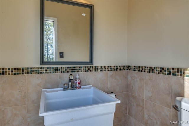 bathroom with tile walls and sink