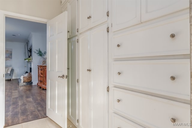 hall featuring light hardwood / wood-style floors and crown molding