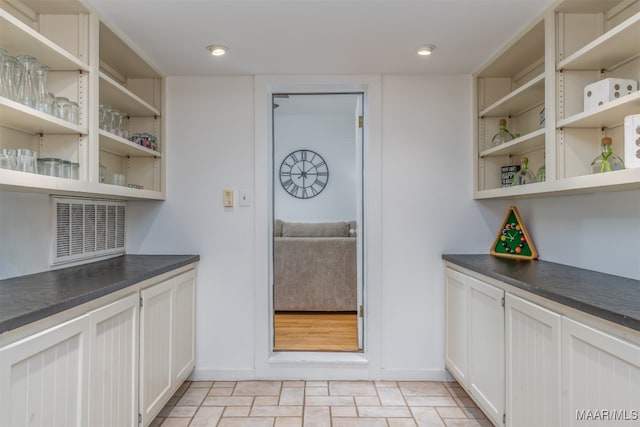 kitchen with white cabinetry and light tile patterned flooring