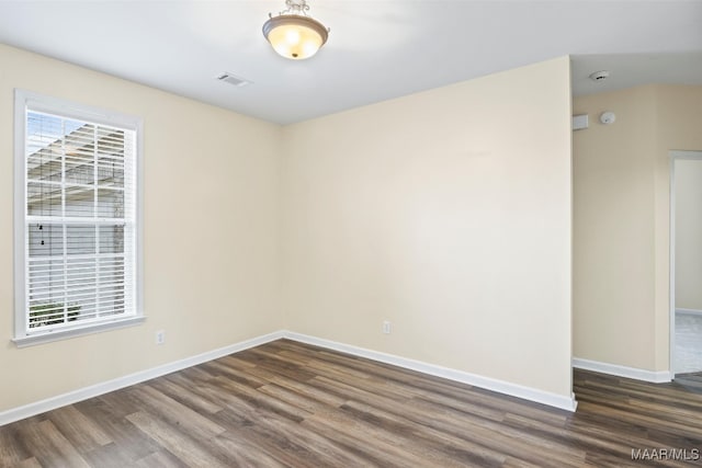 empty room featuring dark wood-type flooring