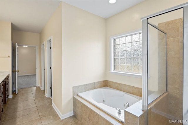 bathroom featuring tile patterned flooring, vanity, and plus walk in shower