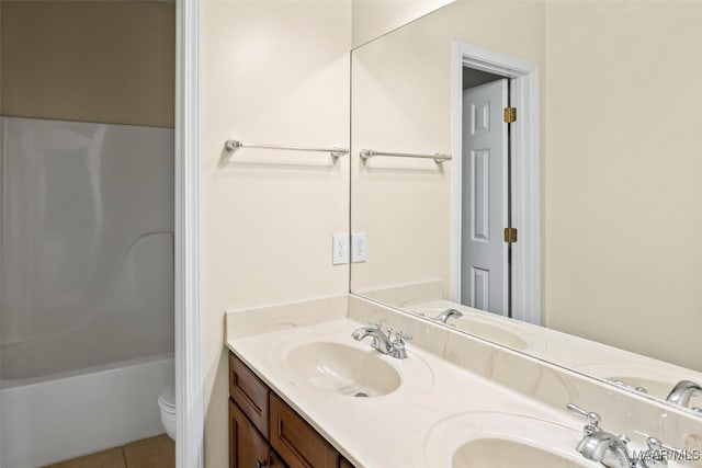 bathroom featuring tile patterned flooring, vanity, and toilet