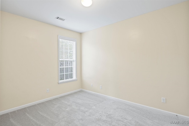 unfurnished room featuring light carpet