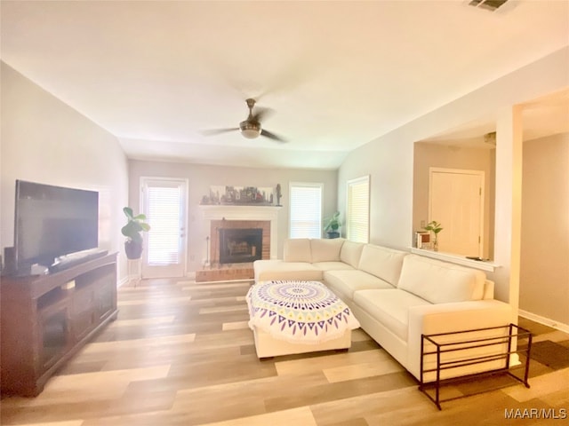 living room featuring hardwood / wood-style floors, vaulted ceiling, and ceiling fan