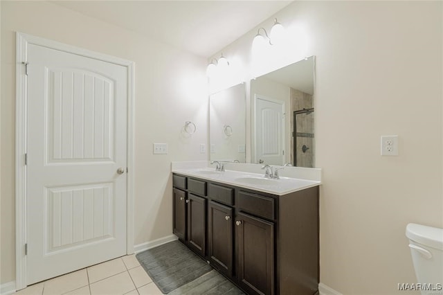 bathroom with vanity, tile patterned floors, toilet, and an enclosed shower