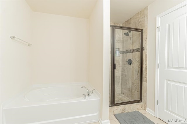 bathroom featuring plus walk in shower and tile patterned flooring