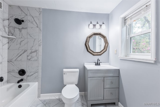 full bathroom featuring vanity, tiled shower / bath combo, and toilet