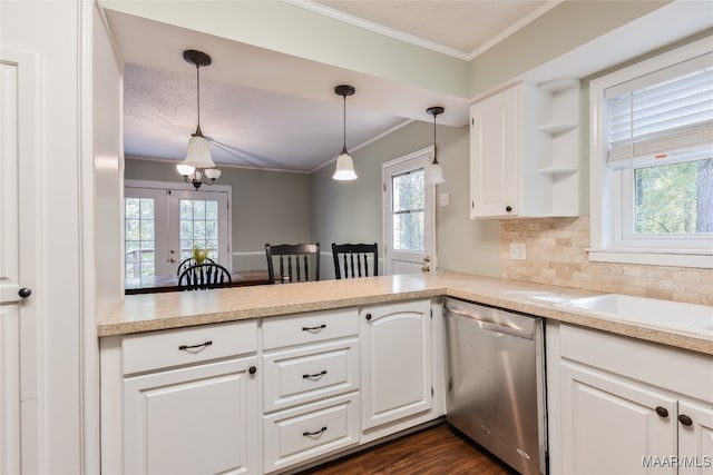 kitchen featuring stainless steel dishwasher, white cabinetry, and decorative light fixtures