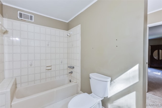 bathroom with tiled shower / bath, toilet, and crown molding