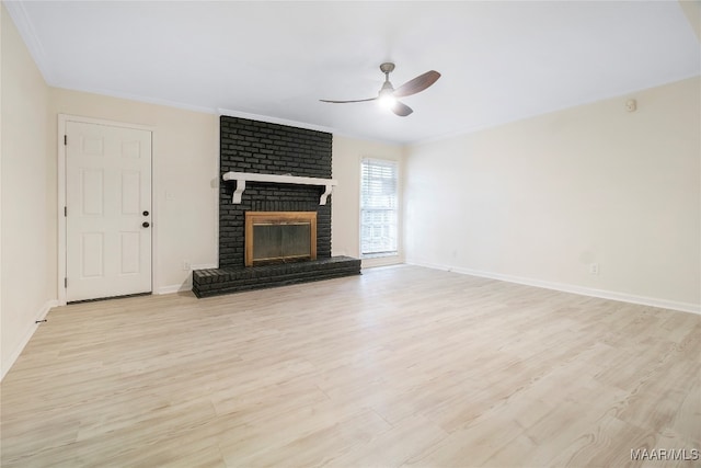 unfurnished living room with a fireplace, light hardwood / wood-style flooring, ceiling fan, and crown molding