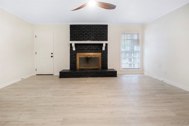 unfurnished living room with ornamental molding, a fireplace, light hardwood / wood-style floors, and ceiling fan