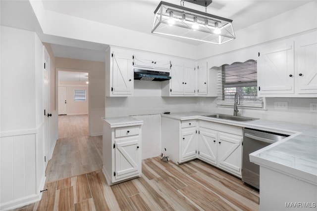 kitchen with hanging light fixtures, white cabinets, and sink