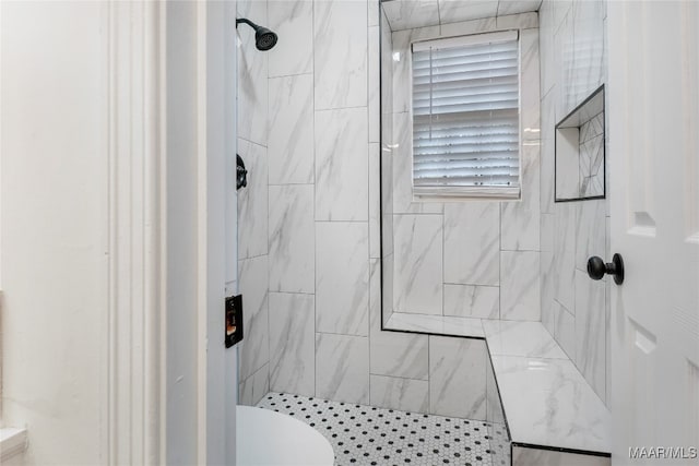 bathroom featuring toilet and a tile shower