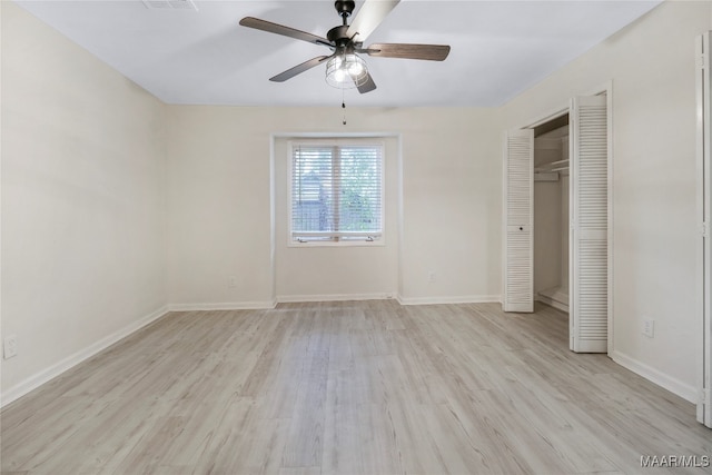 unfurnished bedroom with light hardwood / wood-style flooring, ceiling fan, and a closet