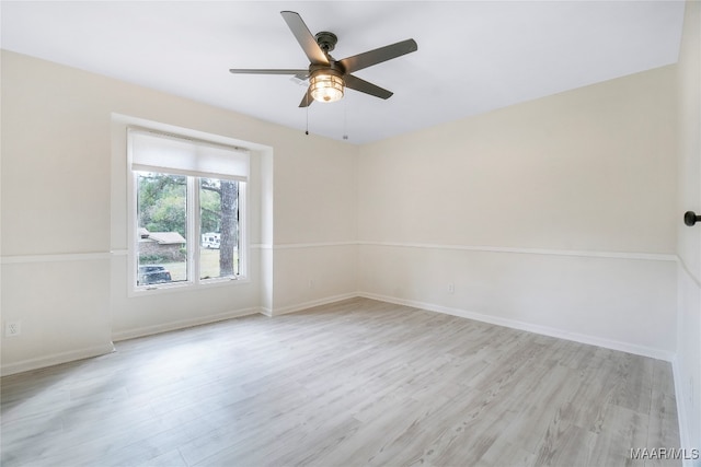 spare room with light hardwood / wood-style floors and ceiling fan