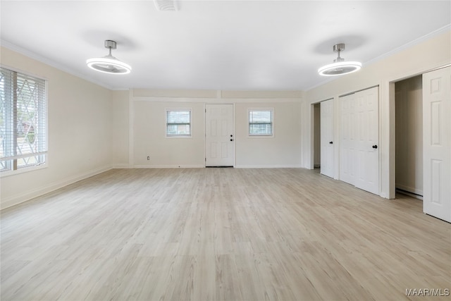 interior space featuring light hardwood / wood-style floors and crown molding