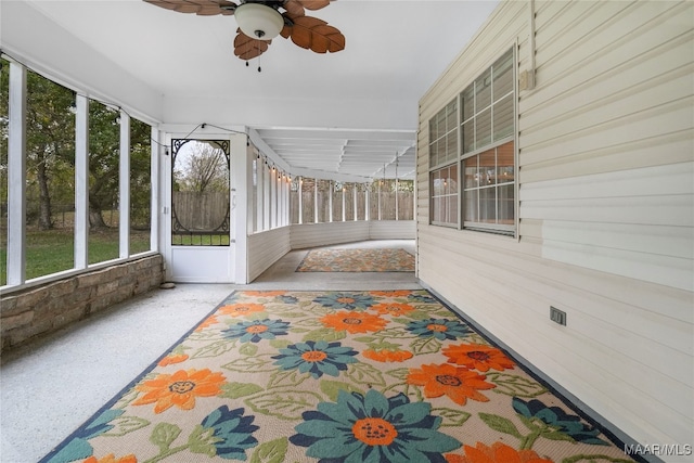 sunroom featuring ceiling fan