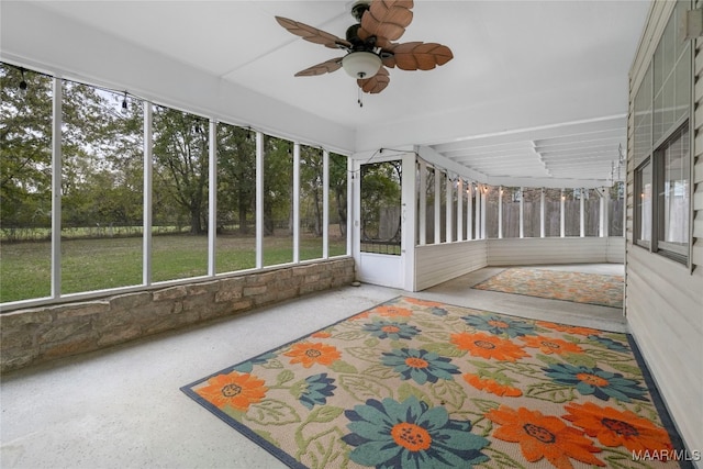 unfurnished sunroom with ceiling fan