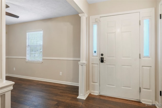 foyer with ornate columns, dark hardwood / wood-style flooring, a textured ceiling, and ceiling fan