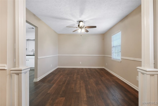 empty room with sink, ceiling fan, a textured ceiling, and dark hardwood / wood-style floors