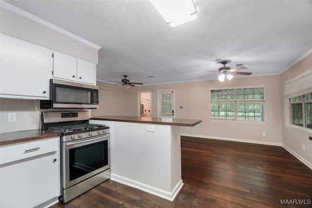 kitchen with white cabinets, kitchen peninsula, stainless steel appliances, and dark hardwood / wood-style flooring