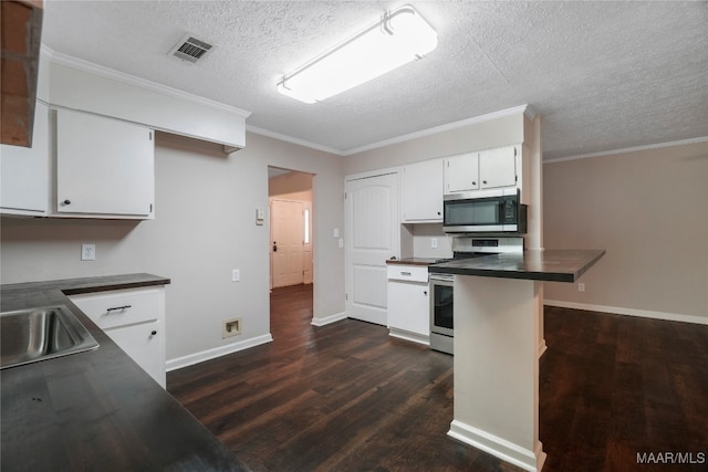 kitchen with stainless steel appliances, dark wood-type flooring, white cabinets, a textured ceiling, and ornamental molding