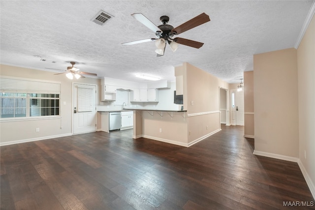 interior space with white cabinets, dark hardwood / wood-style floors, and kitchen peninsula