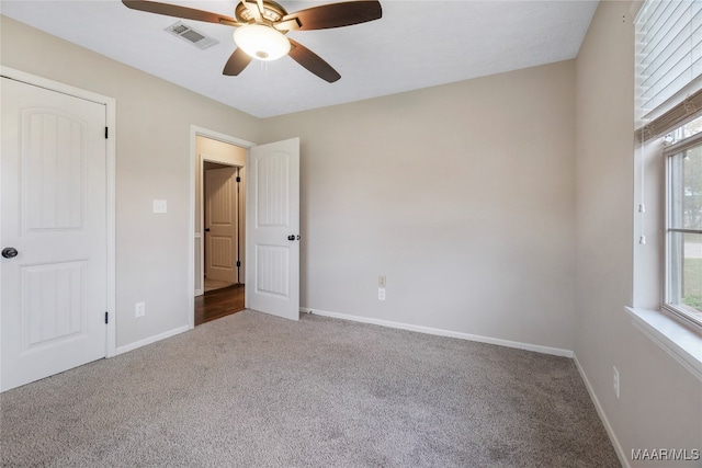 unfurnished bedroom with a closet, ceiling fan, and carpet floors