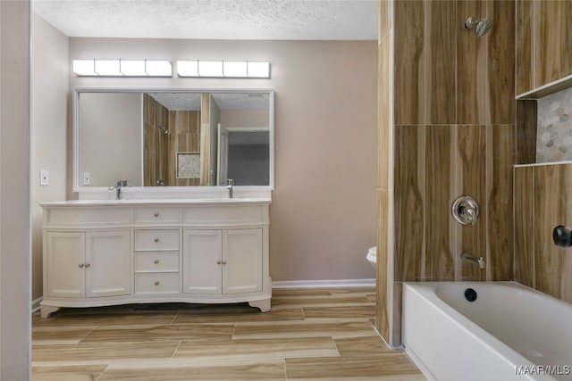 full bathroom with shower / tub combination, vanity, a textured ceiling, and toilet