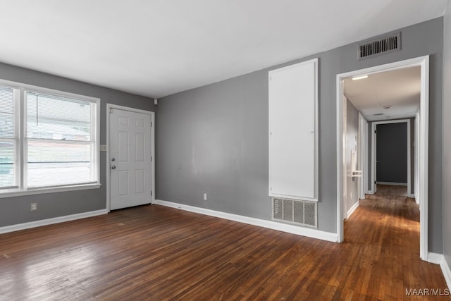 unfurnished room featuring dark hardwood / wood-style floors