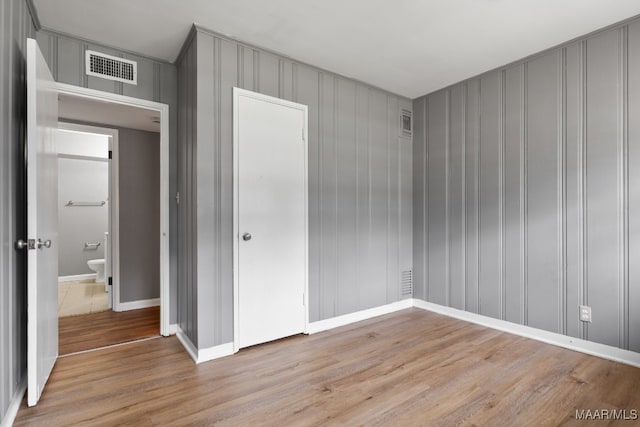 unfurnished bedroom with light wood-type flooring