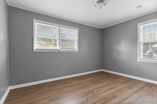 spare room with light hardwood / wood-style floors and ornamental molding