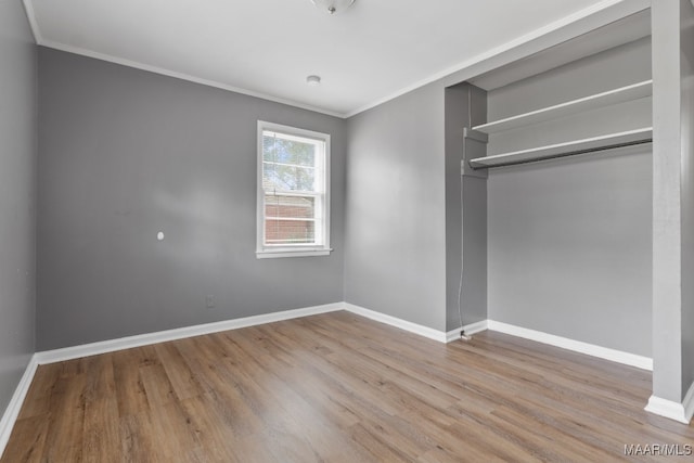 unfurnished bedroom featuring light hardwood / wood-style floors, a closet, and ornamental molding