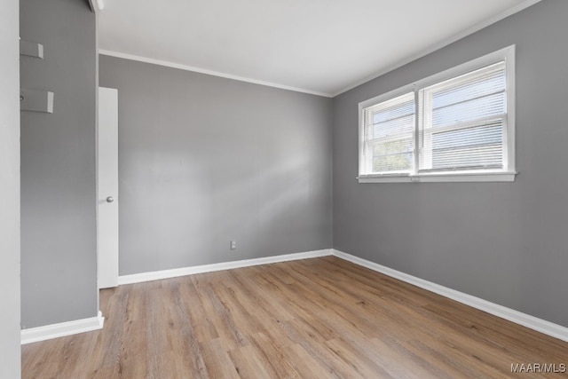 unfurnished room with light hardwood / wood-style flooring and ornamental molding