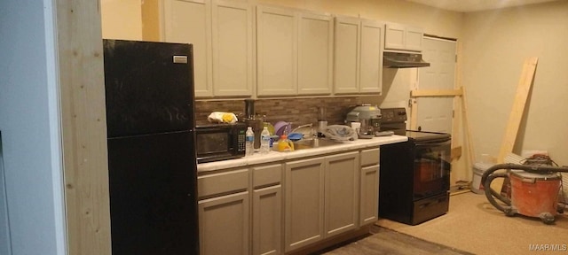 kitchen featuring black appliances, backsplash, and sink