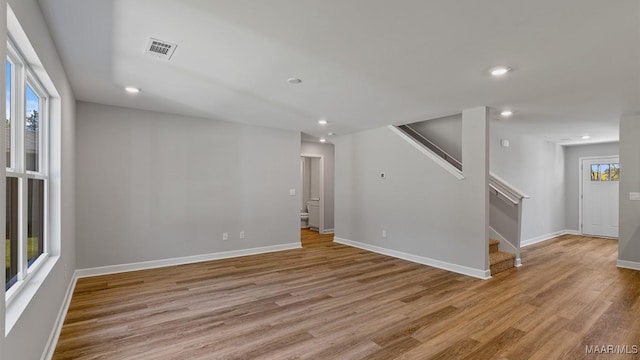 unfurnished room featuring light wood-type flooring and a wealth of natural light