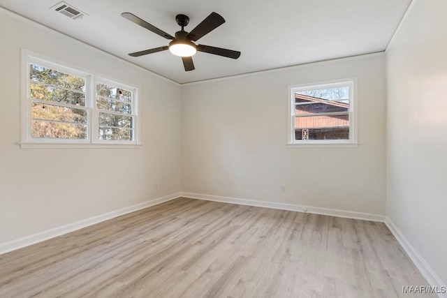 spare room with ceiling fan, ornamental molding, and light wood-type flooring