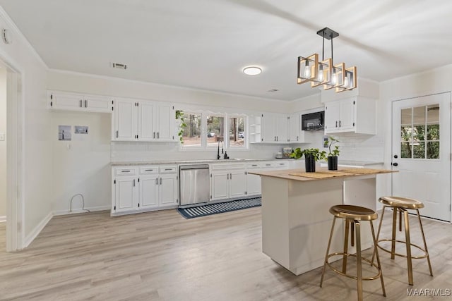 kitchen featuring decorative light fixtures, dishwasher, a healthy amount of sunlight, decorative backsplash, and white cabinets