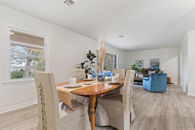 dining space with a healthy amount of sunlight and light wood-type flooring