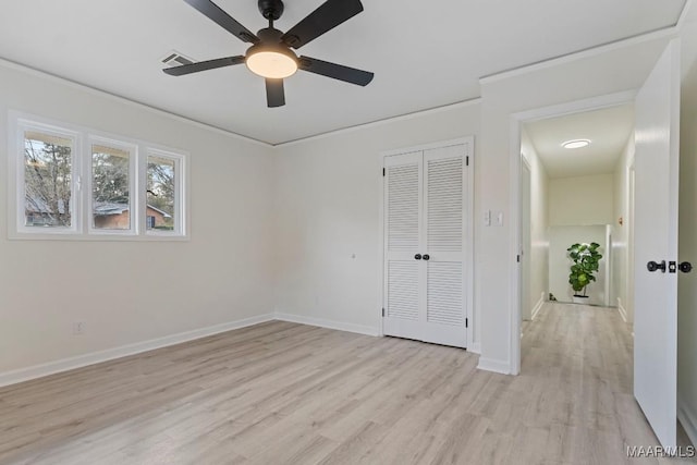 unfurnished bedroom with a closet, ornamental molding, ceiling fan, and light hardwood / wood-style floors