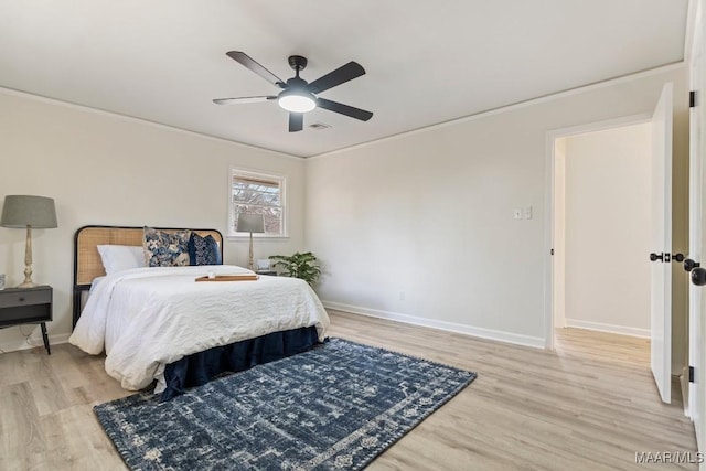 bedroom with ceiling fan, ornamental molding, and light hardwood / wood-style floors