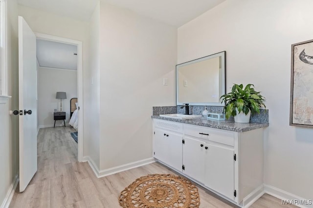 bathroom featuring vanity and hardwood / wood-style flooring