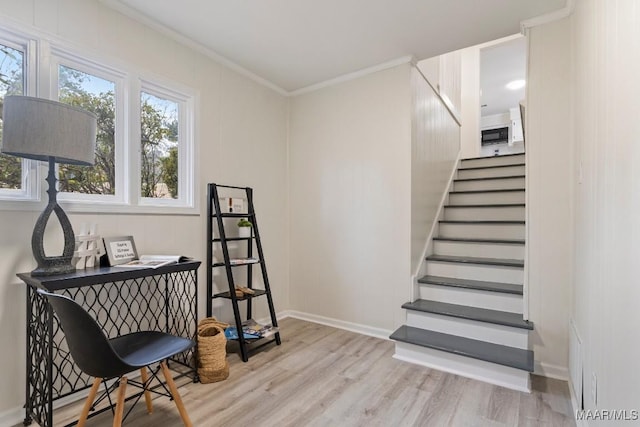 stairway featuring ornamental molding and wood-type flooring