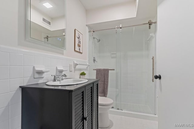 bathroom featuring vanity, tile walls, an enclosed shower, and toilet