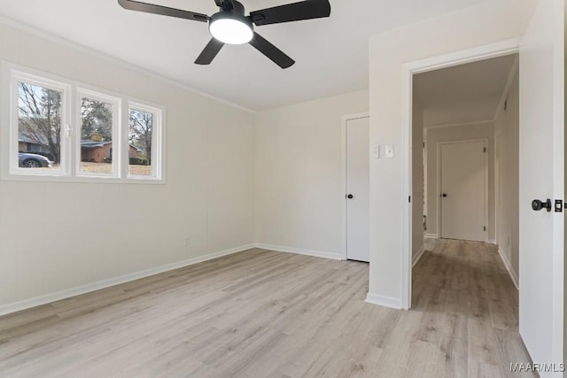 empty room with ceiling fan and light wood-type flooring