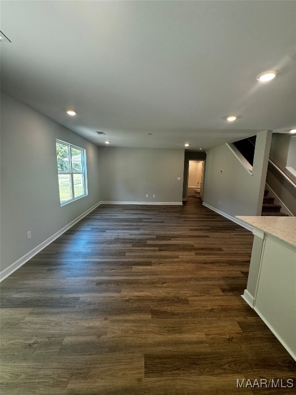 empty room with dark hardwood / wood-style flooring