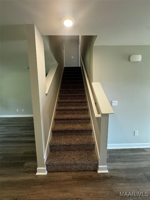 stairs featuring wood-type flooring