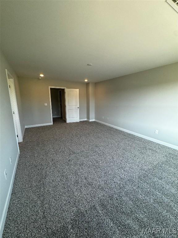 interior space with a closet and dark colored carpet