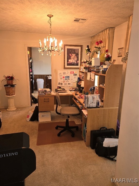 carpeted office space with an inviting chandelier and a textured ceiling